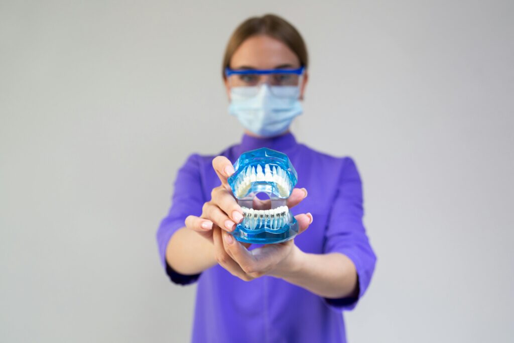 a woman holding out dental implants